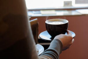 A person holding a latte.